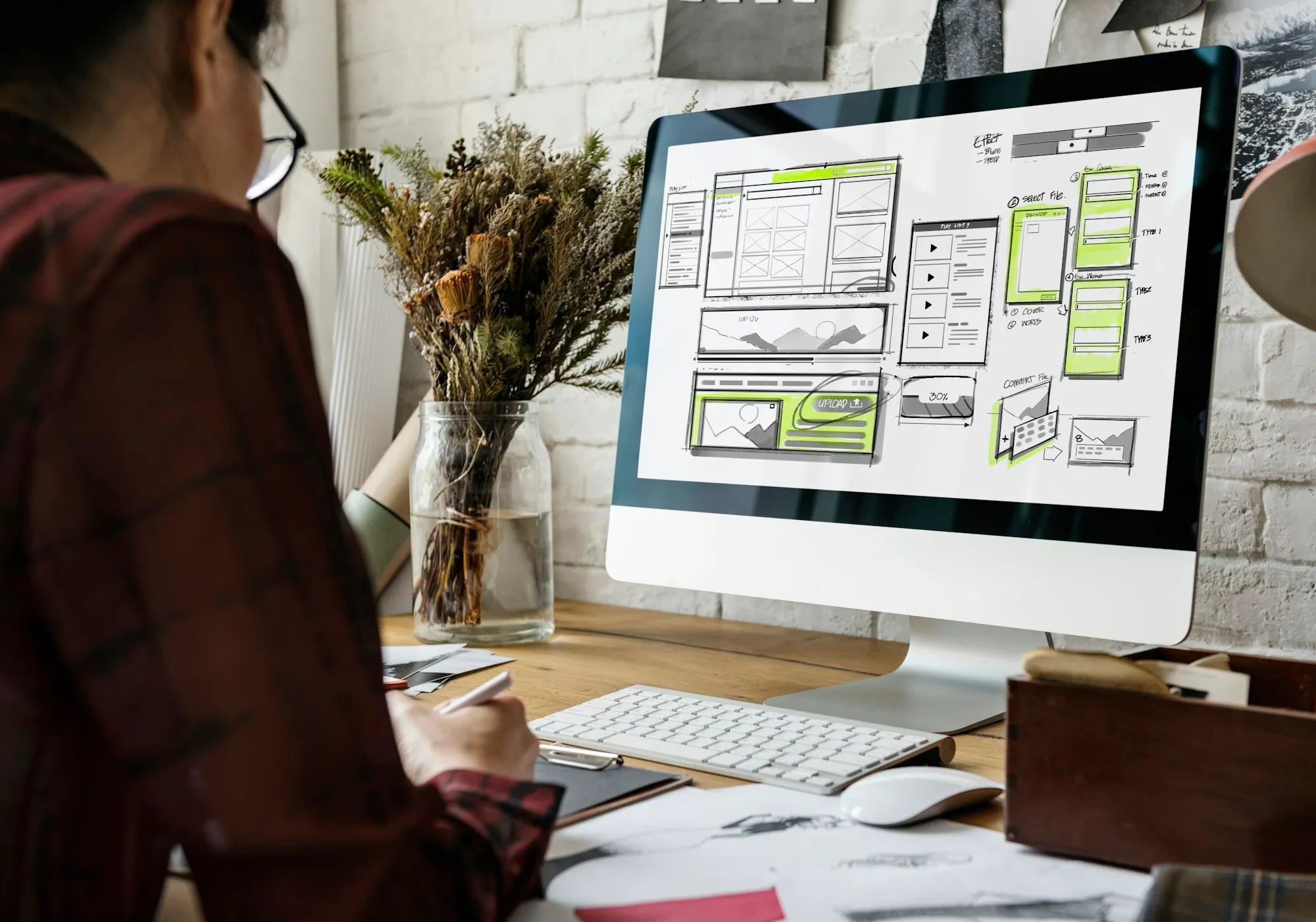 Pencil sketch of a website layout with wireframe boxes on paper